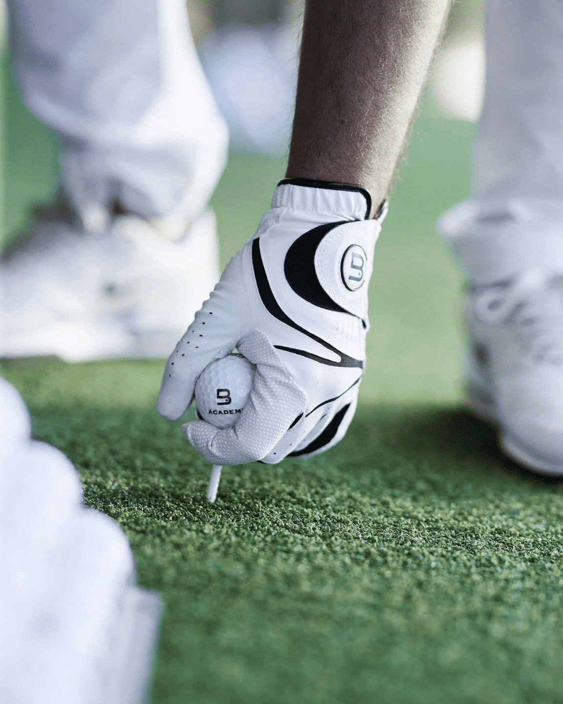 Hand with glove hold golf ball