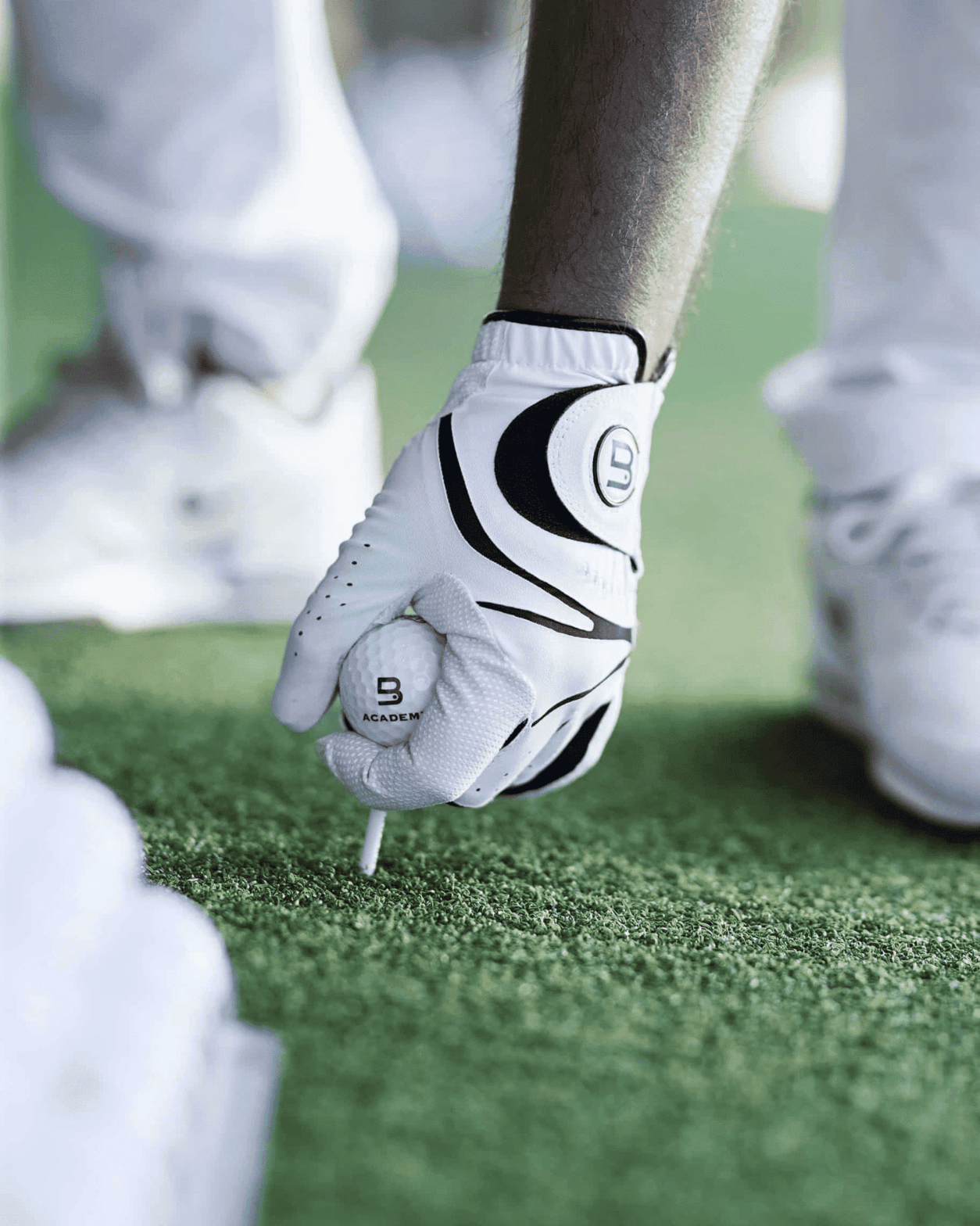 Hand with glove hold golf ball